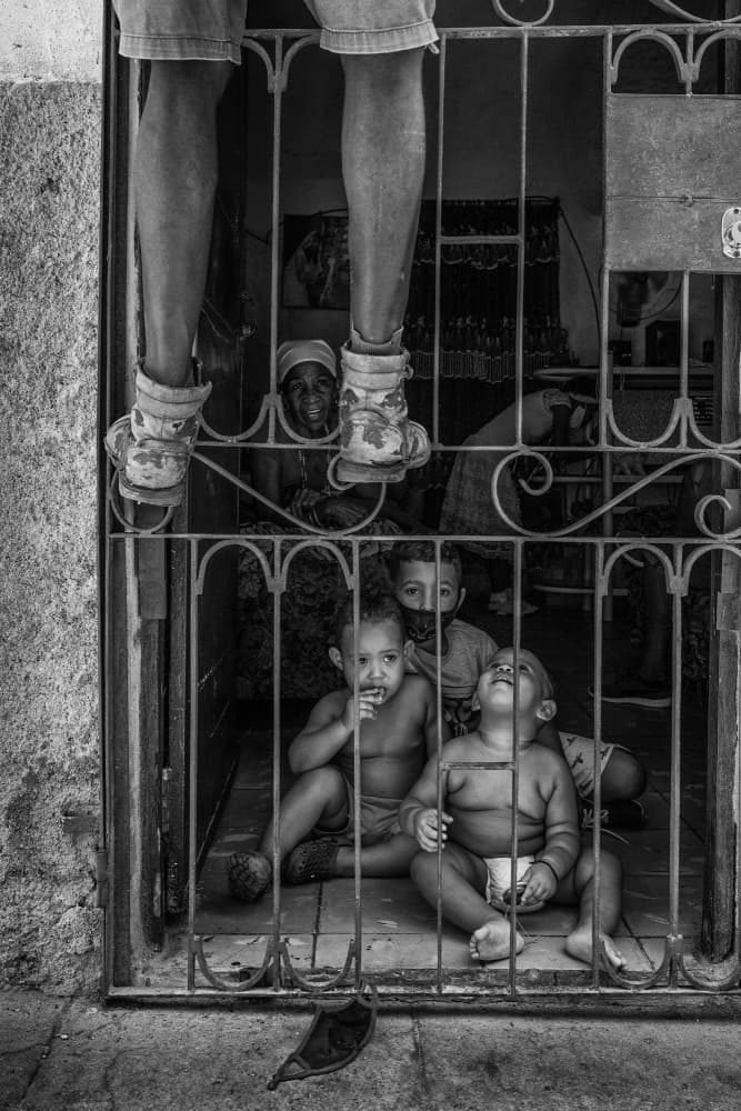 Children Behind Gate by Ali Khataw — canvas wall art