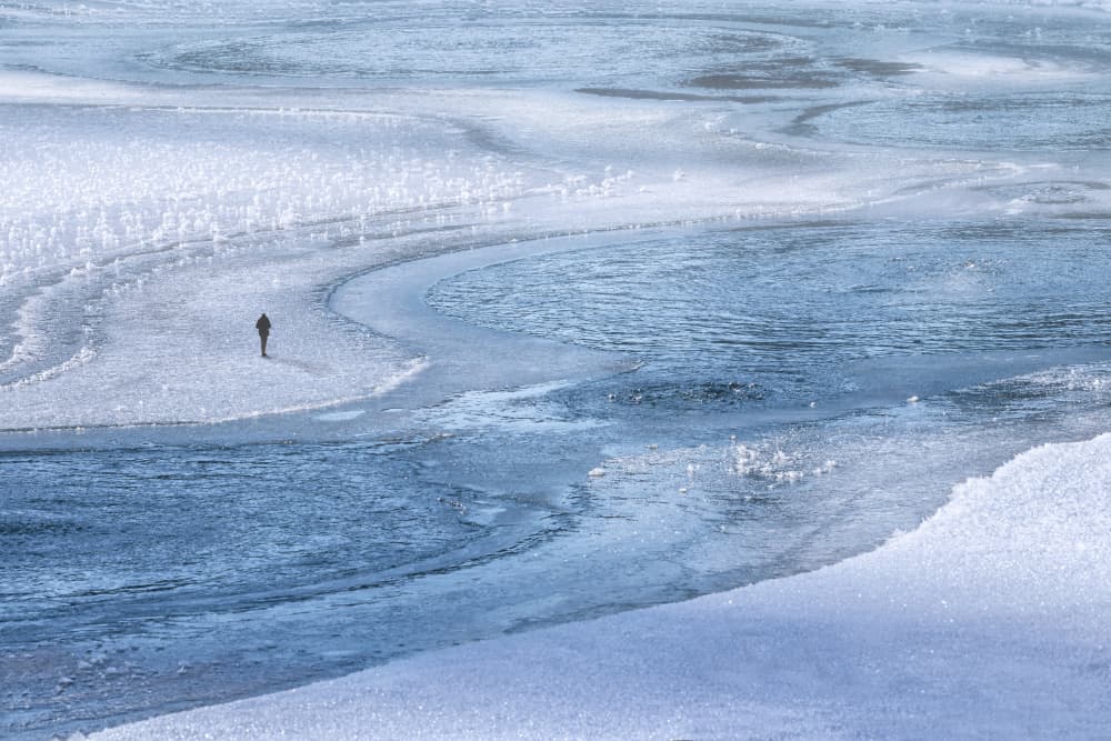 Lone Figure Frozen Lake by Uschi Hermann — canvas wall art