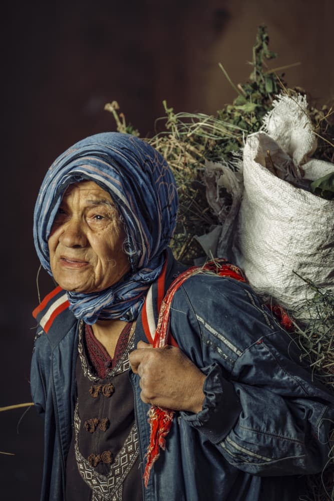 Resilient Woman Carrying Load by wail.Hamdane — canvas wall art