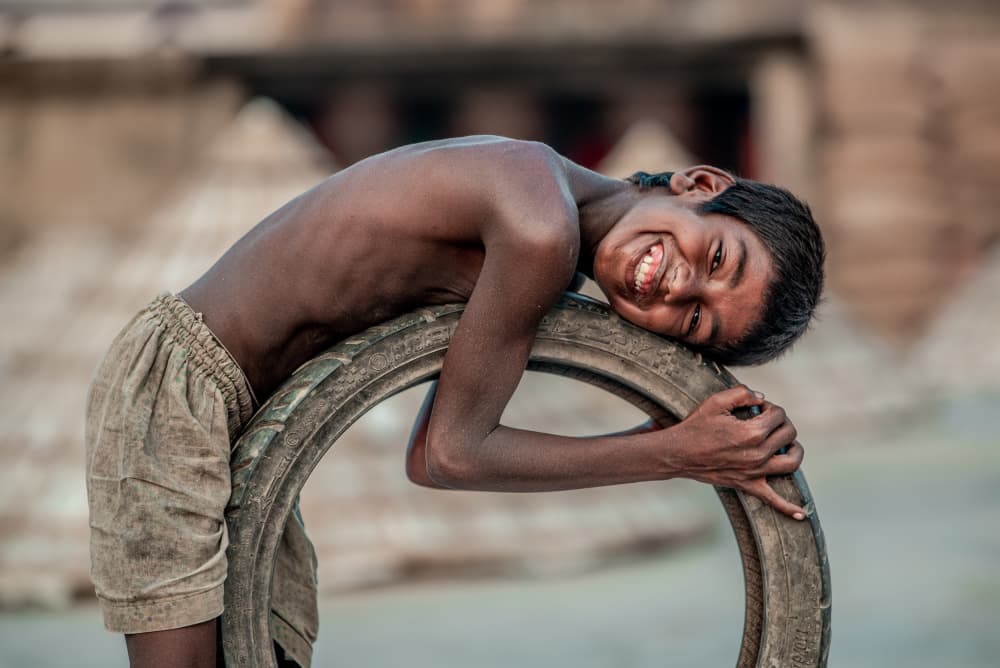 Joyful Boy On Tire by Rakibul Alam Khan — canvas wall art