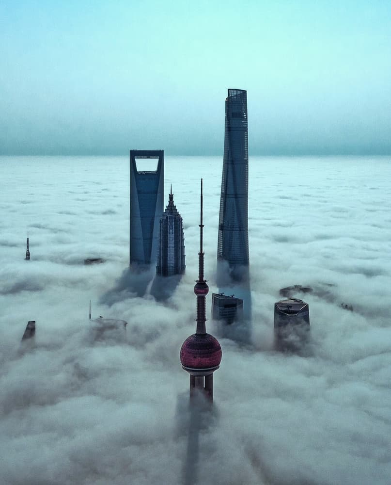 Skyscrapers Above Clouds by Stan Huang — canvas wall art