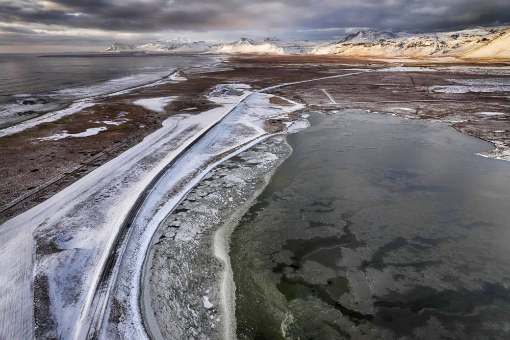 Frozen Coastal Road to Mountains by Þorsteinn H. Ingibergsson — canvas wall art