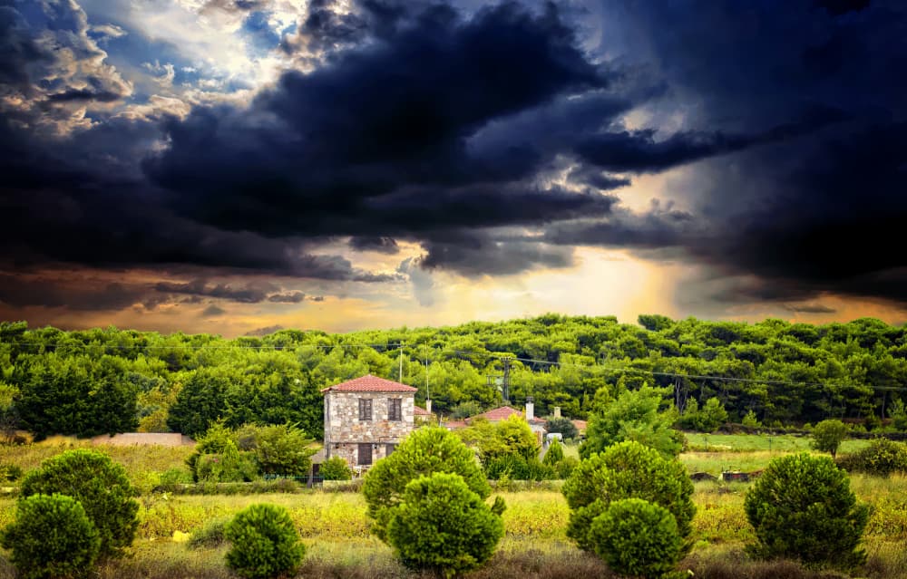 Dramatic Sky Over Stone House by Merthan Kortan — canvas wall art