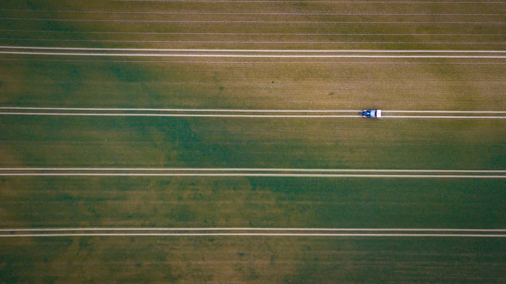 Tractor Working Green Field by Kutub Uddin — canvas wall art