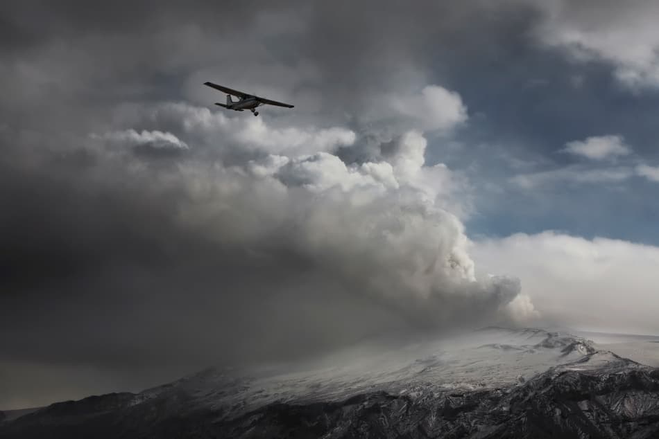 Airplane Over Smoking Volcano by Bragi Ingibergsson - BRIN — canvas wall art