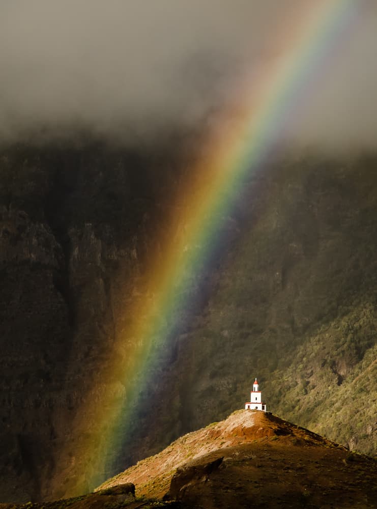Rainbow Over Hilltop Chapel by Piera Polo — canvas wall art