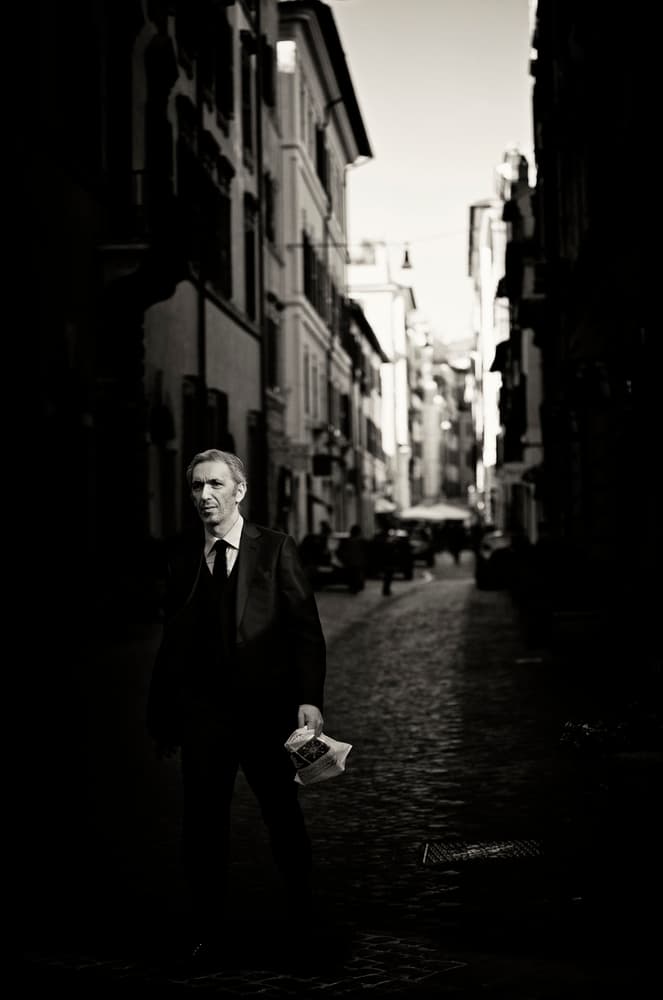 Man On Cobblestone Street by Julien Oncete — canvas wall art
