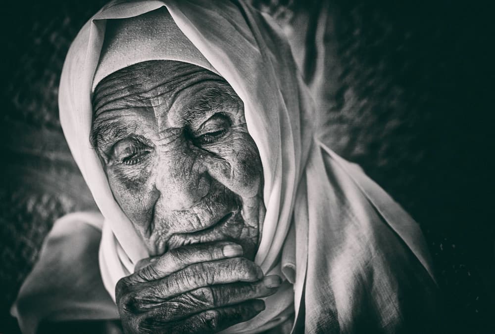 Elderly Woman Praying by Rami Al Adwan — canvas wall art