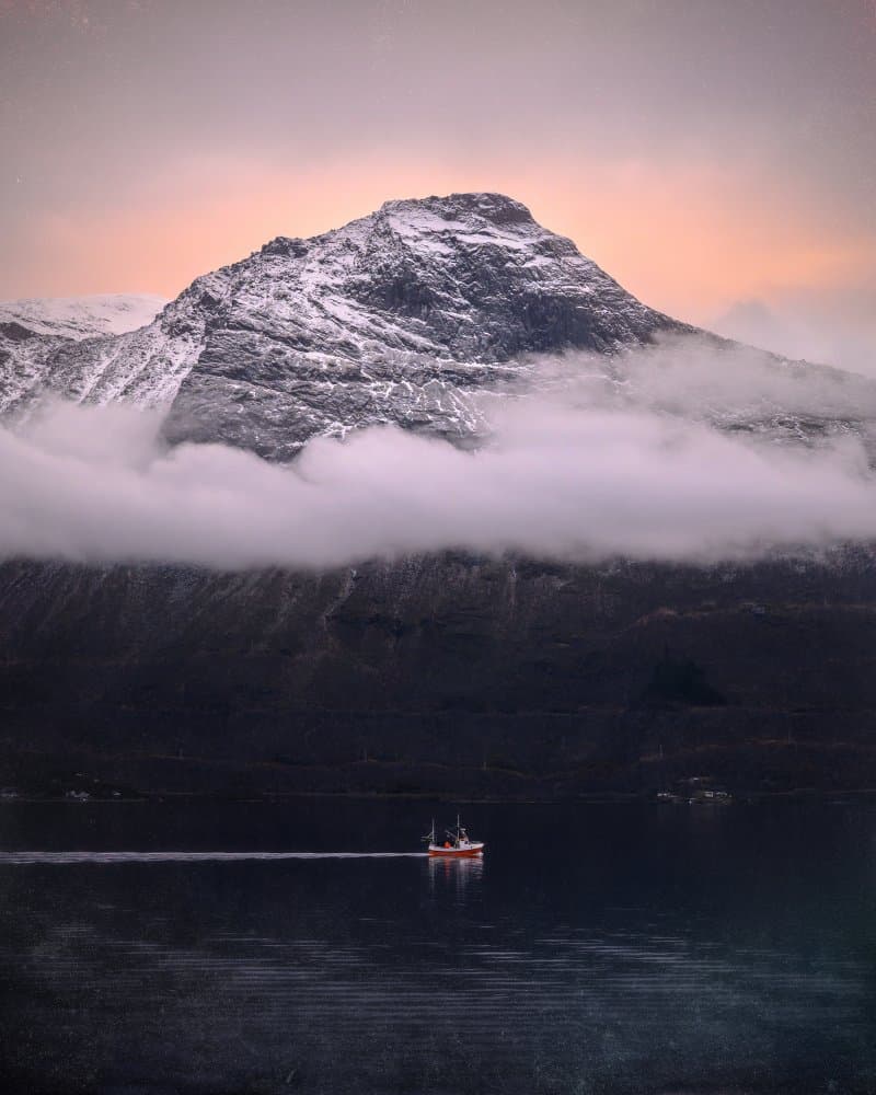 Snowy Peaks Fjord Boat by Kaspars Kurcens — canvas wall art