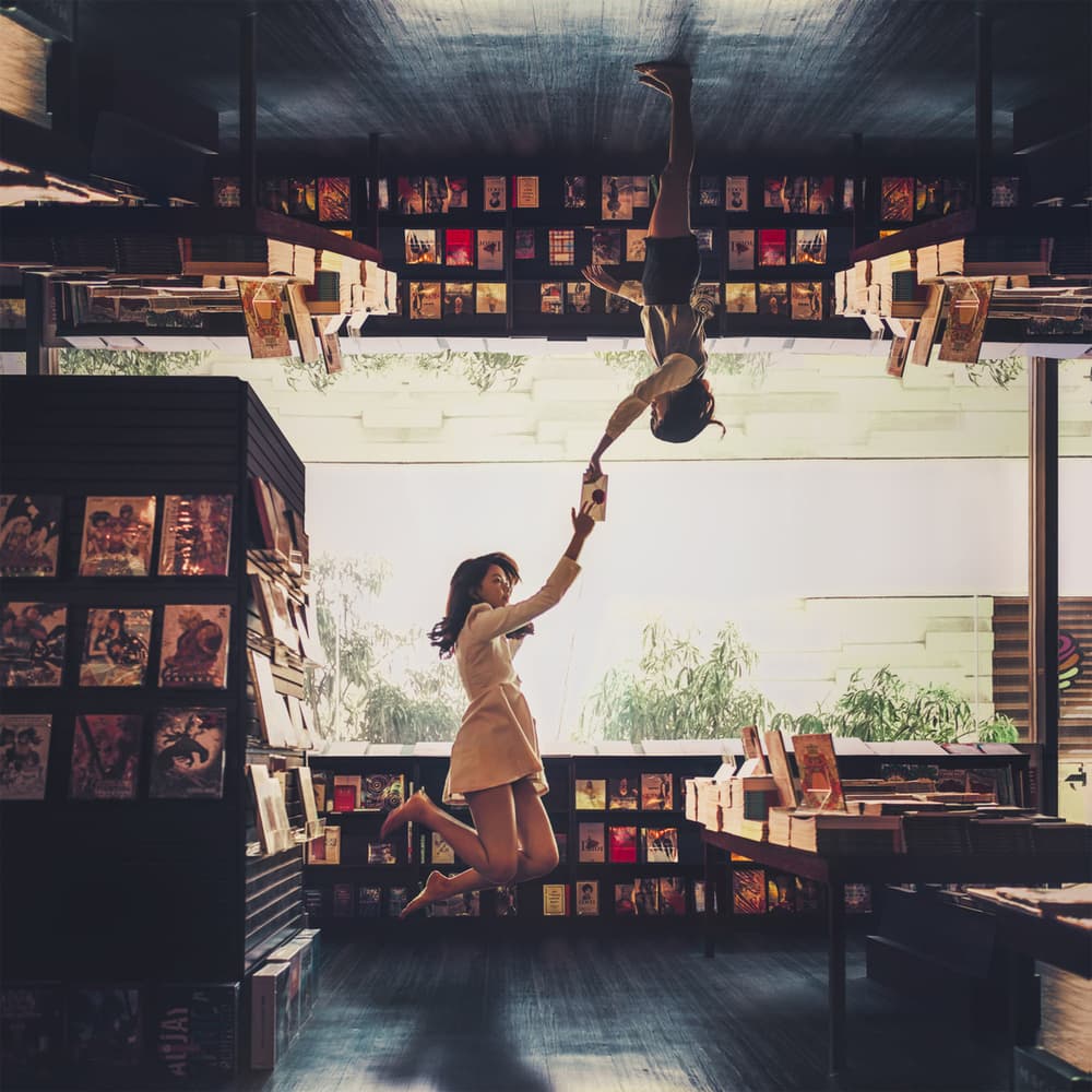Floating Book Lovers by CJ Tajonera Bio — canvas wall art