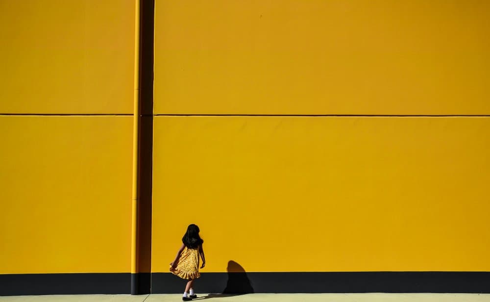 Little Girl Yellow Wall by Anindita Roy — canvas wall art