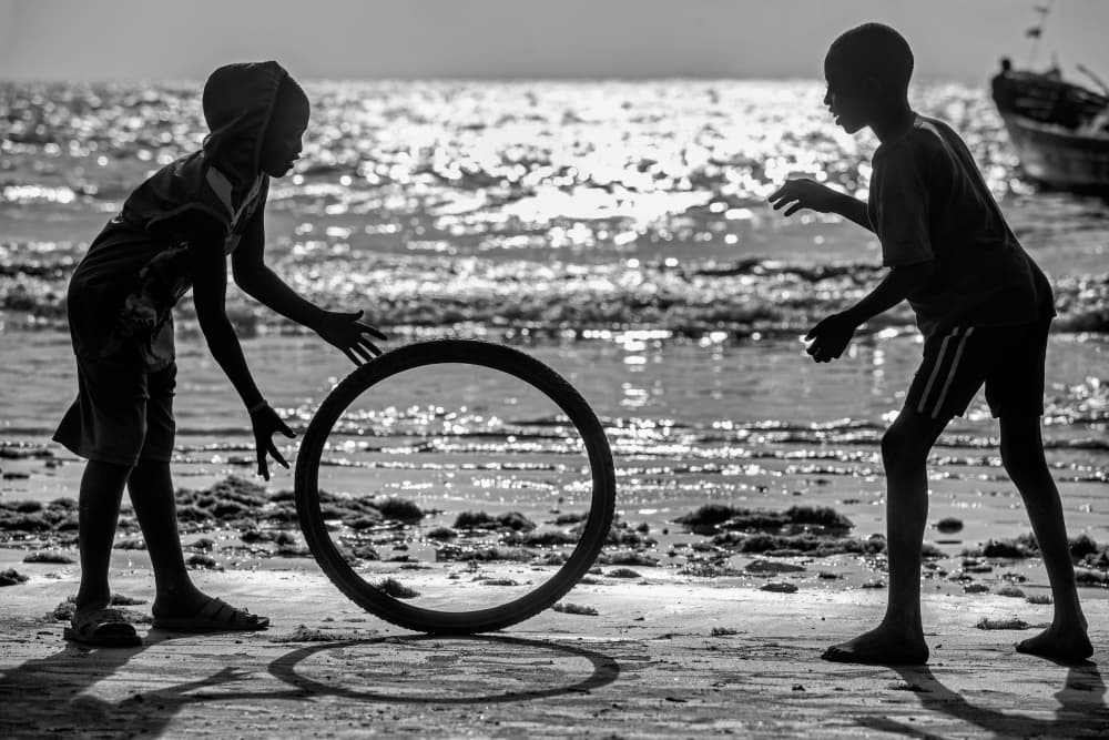 Boys Playing Beach Hoop by Milton Louiz — canvas wall art