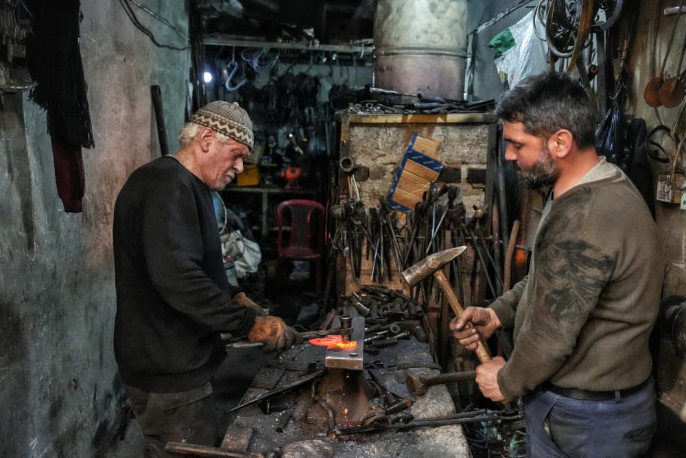 Blacksmiths Forging Hot Metal by Bashar Alsofey — canvas wall art