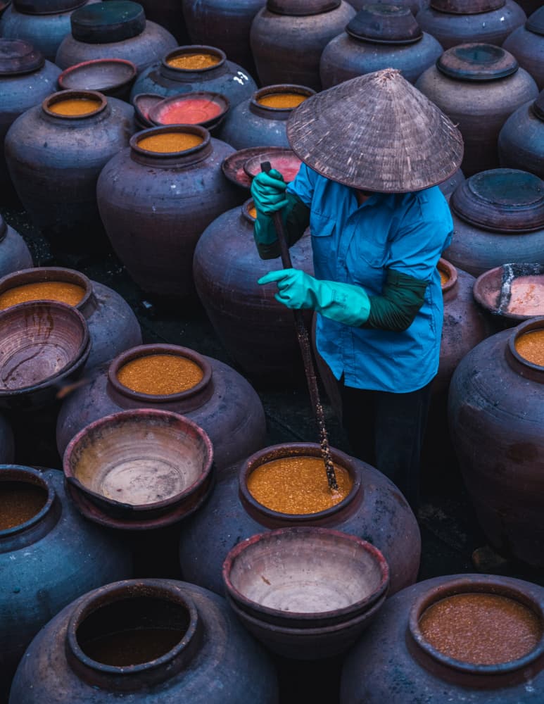 Stirring Traditional Pots by Jyoti Prakash Sarmah — canvas wall art