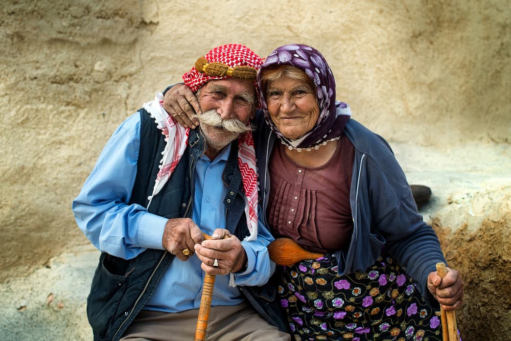 Smiling Elderly Couple by Burak Senbak — canvas wall art