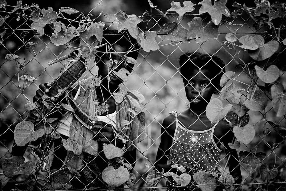 Pensive Children Through Fence by Luís Godinho — canvas wall art