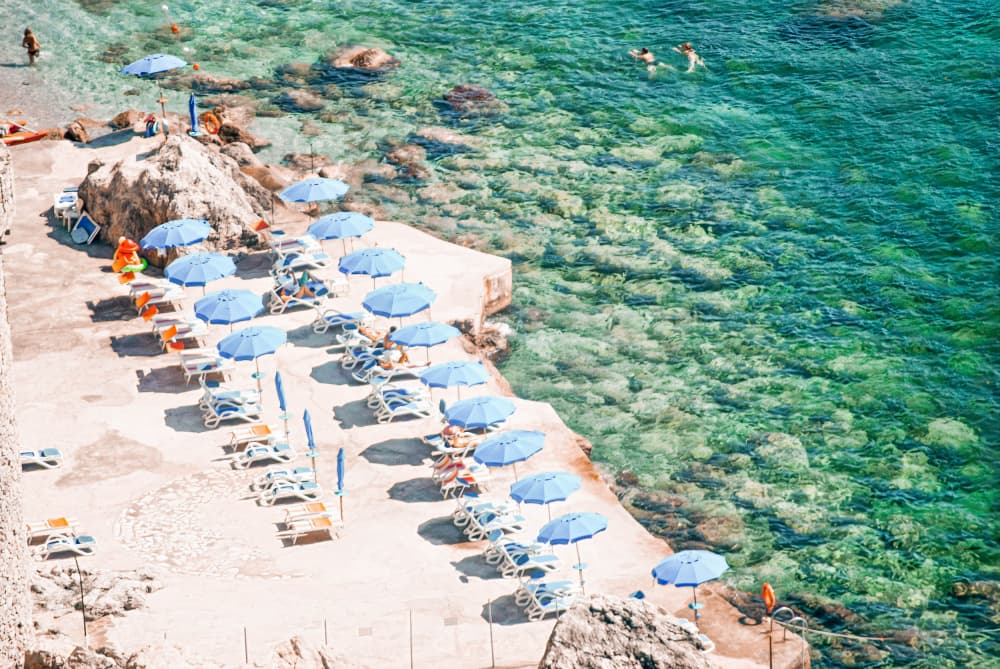 Blue Umbrellas Seaside Retreat by Talitha McQueen — canvas wall art