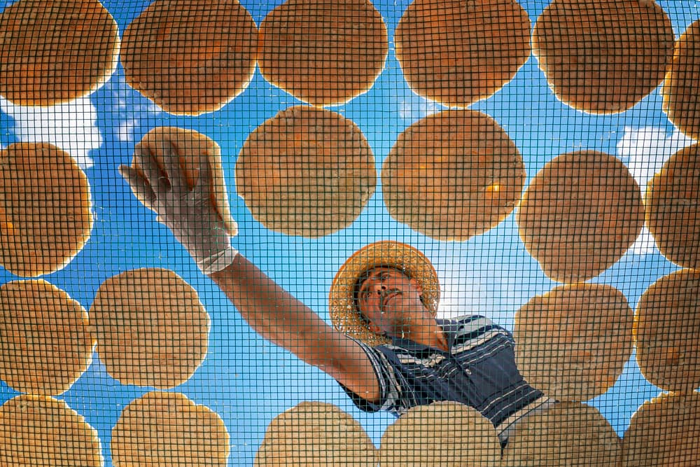 Man Sun Drying Food by Suleyman Uzumcu — canvas wall art