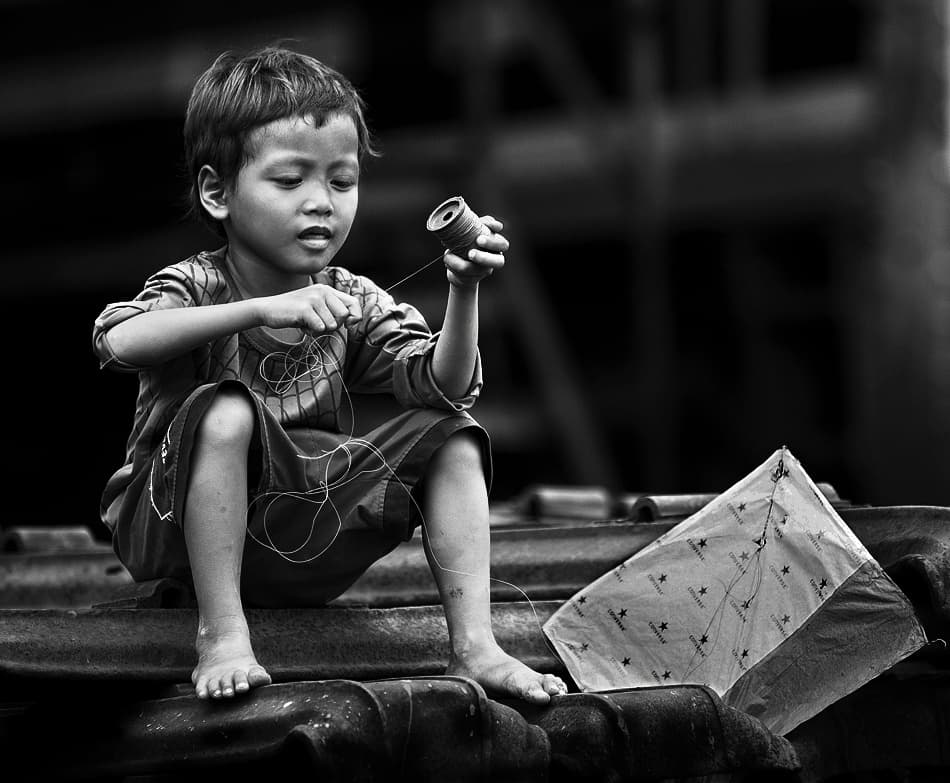 Young Boy Prepares Kite by Sebastian Kisworo — canvas wall art