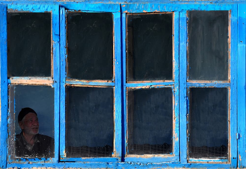 Old Man in Blue Window by Fatma GÖKMEN — canvas wall art