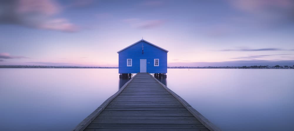 Blue Boathouse Serene Water by Richard Vandewalle — canvas wall art
