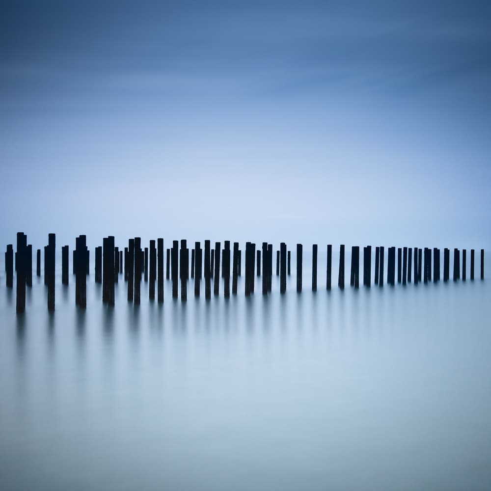 Calm Blue Pilings by Christophe Staelens — canvas wall art