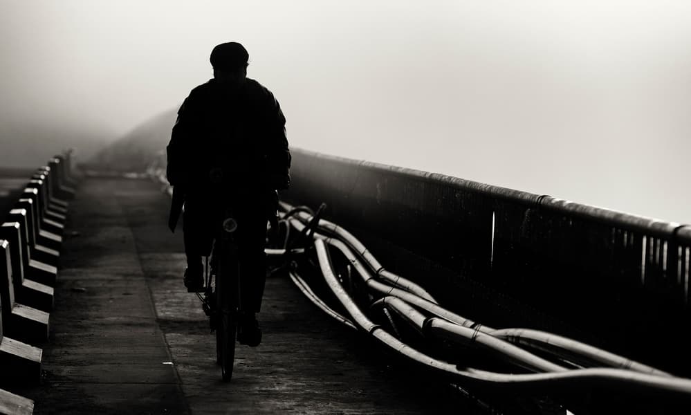 Solitary Cyclist on Bridge by Julien Oncete — canvas wall art