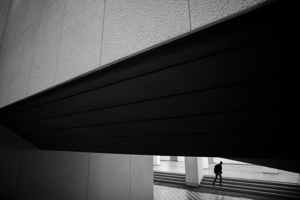 Solitary Figure Ascending Stairs by Satoshi Hata — canvas wall art