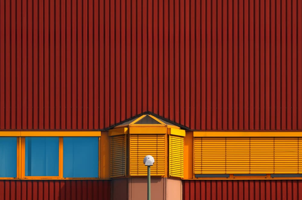 Red Building Yellow Windows by Hans-Wolfgang Hawerkamp — canvas wall art