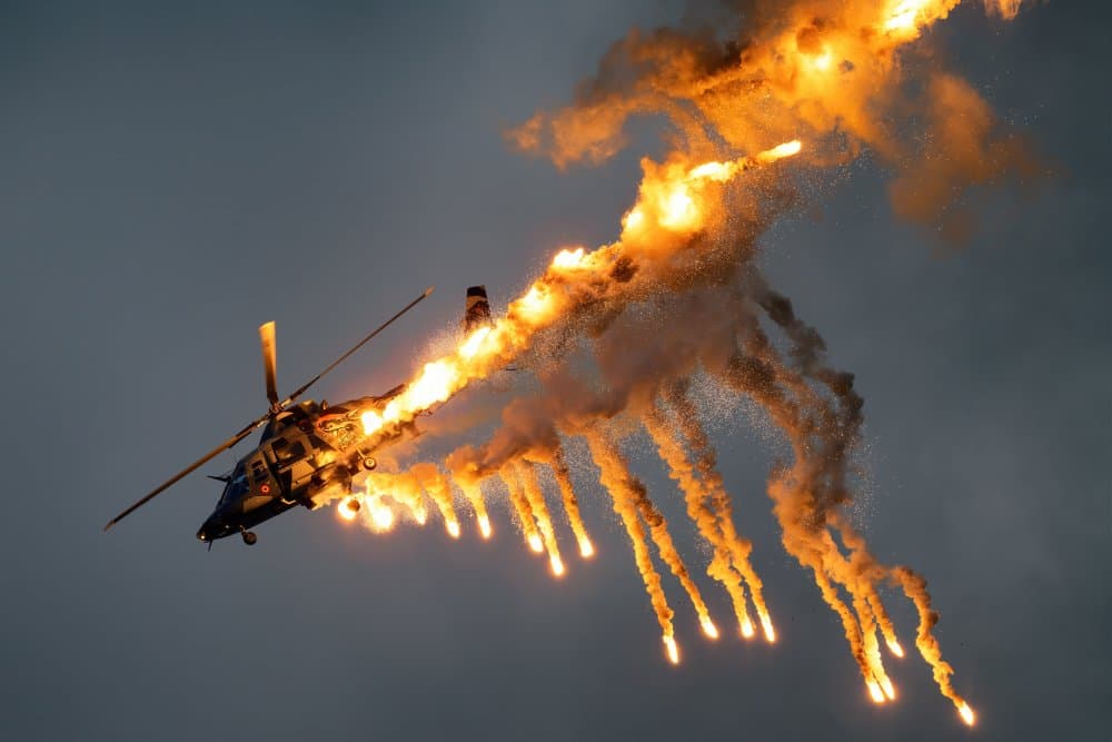 Military Helicopter Flares by Piotr Wrobel — canvas wall art