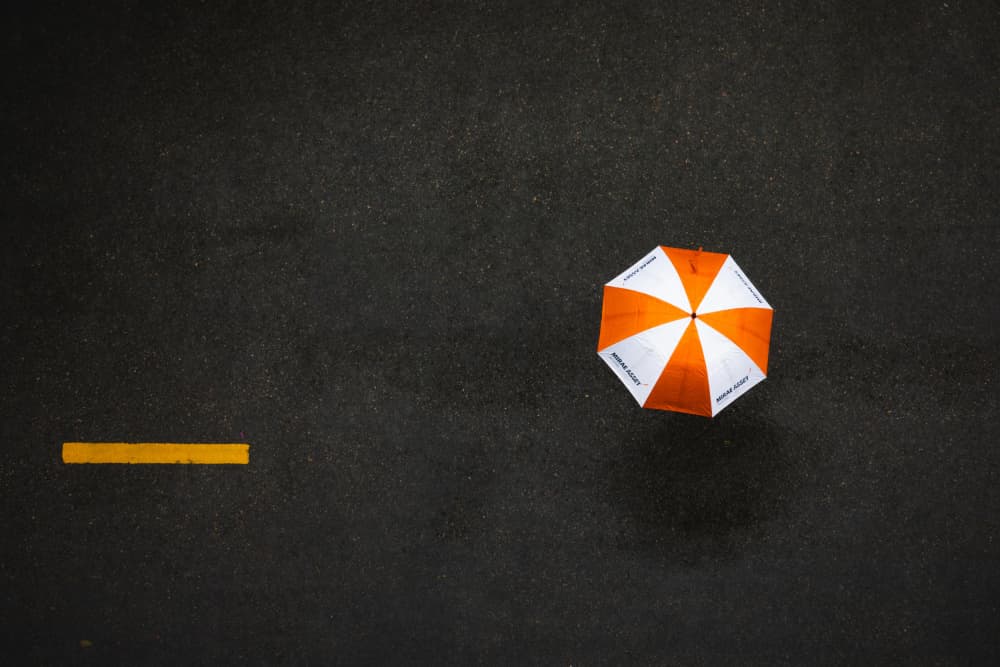 Orange Umbrella Rainy Day by Dzintra Zvagina — canvas wall art