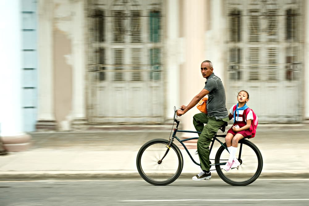 Man And Child City Ride by Luca Domenichi — canvas wall art
