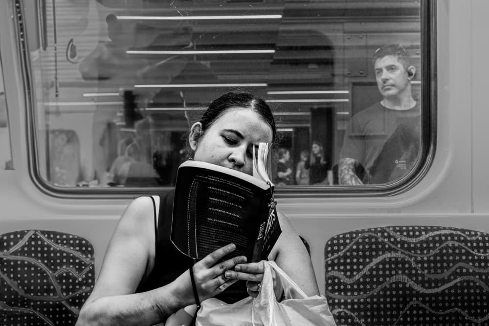 Urban Commute Reading by Corinne Spector — canvas wall art