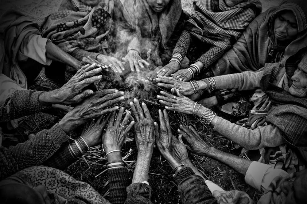 Hands Around Fire by Shaibal Nandi — canvas wall art