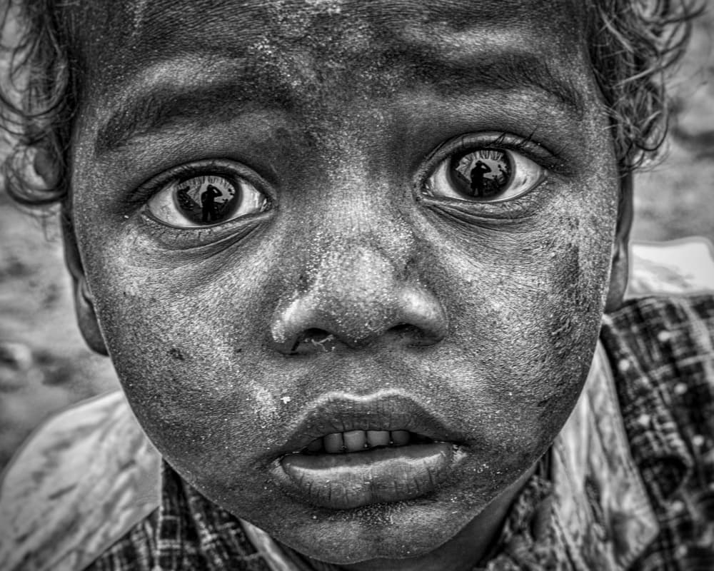 Child's Intense Gaze by JAYATU CHANDRA DAS — canvas wall art