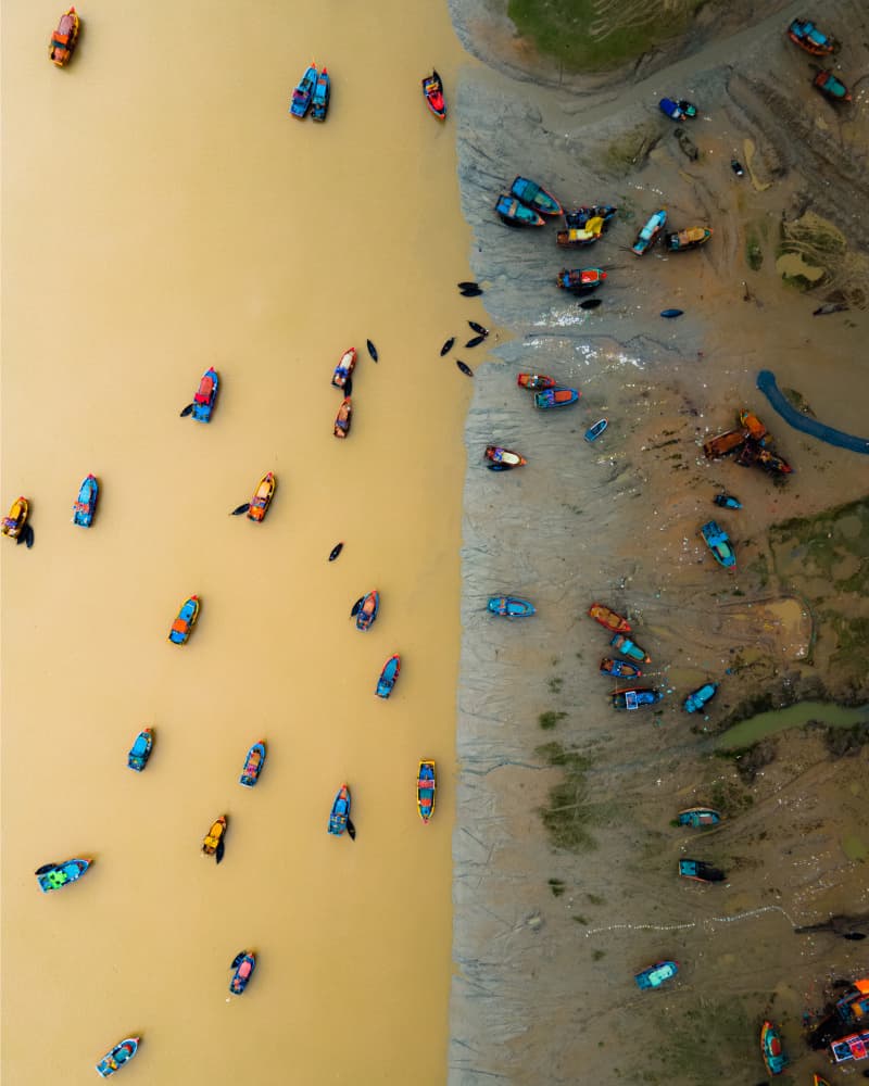 Colorful Boats Muddy Waters by Partha Pritam Mahanta — canvas wall art