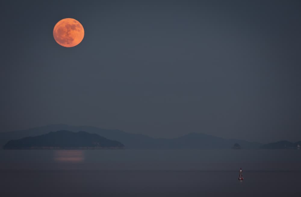 Orange Moon Over Ocean by Sunao Isotani — canvas wall art