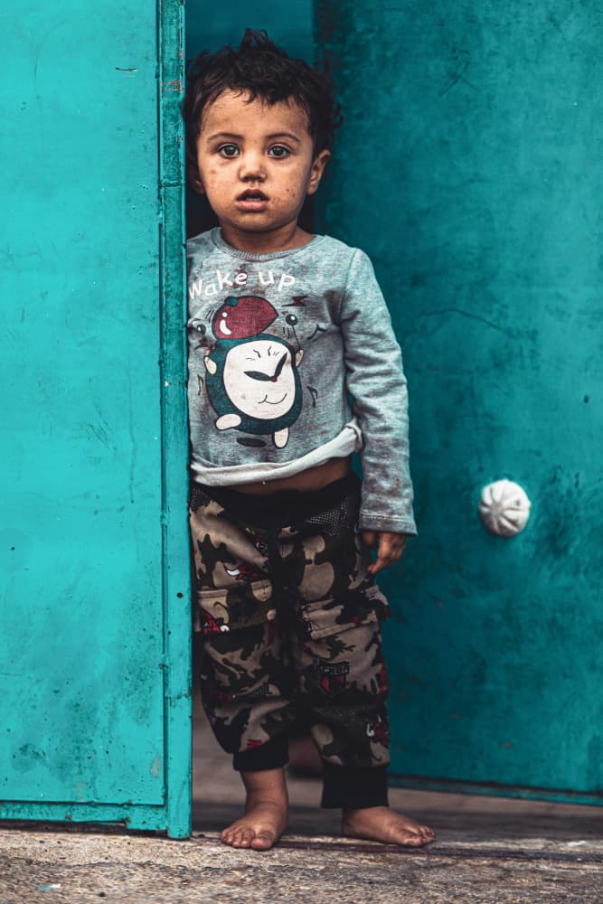 Serious Child Blue Door by Marco Tagliarino — canvas wall art