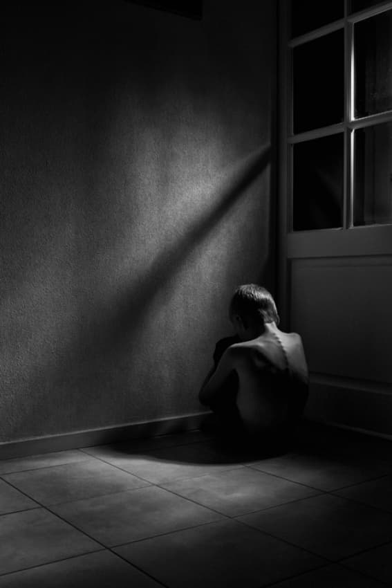 Child In Shadowed Corner by Mirjam Delrue — canvas wall art
