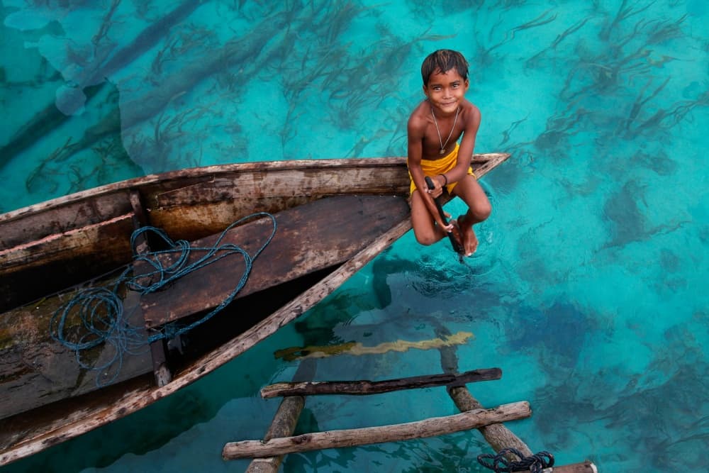 Smiling Boy Blue Water by Hesham Alhumaid — canvas wall art