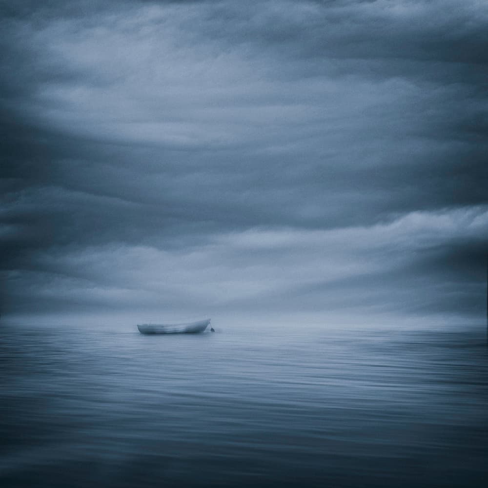Solitary Boat Moody Sky by Joanna Maciszka — canvas wall art