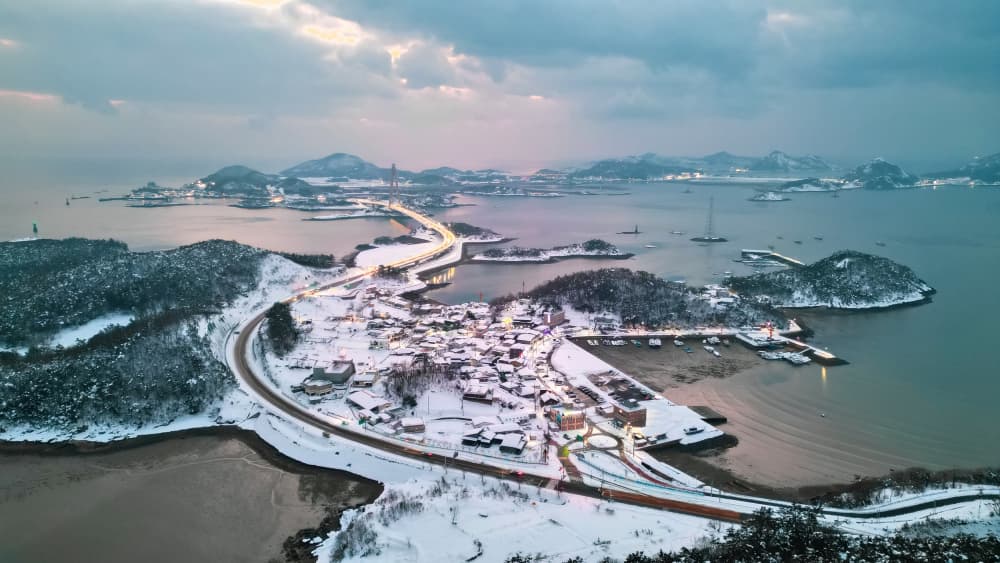 Snowy Coastal Village by MIN CHEOL KIM — canvas wall art