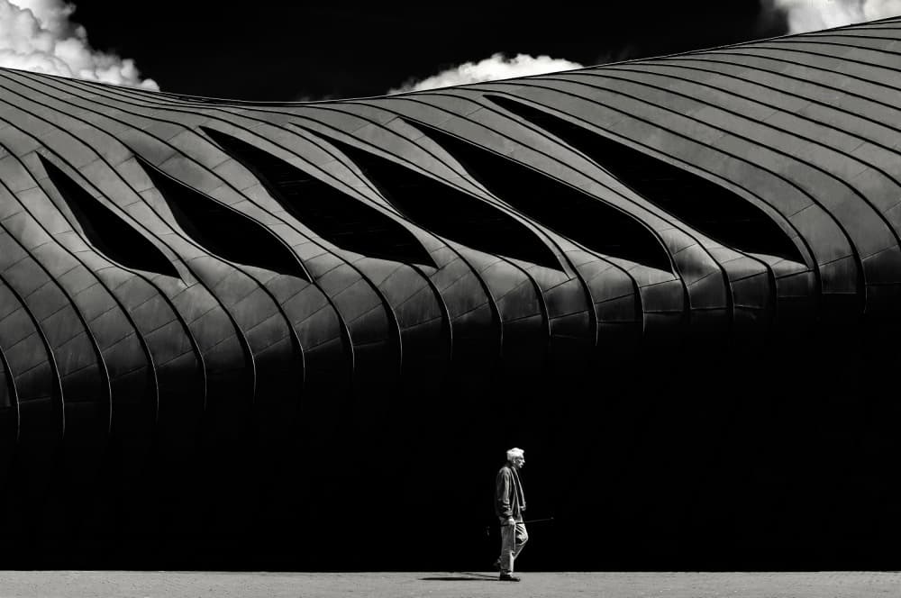 Solitary Figure Curved Building by Padurariu Alexandru — canvas wall art