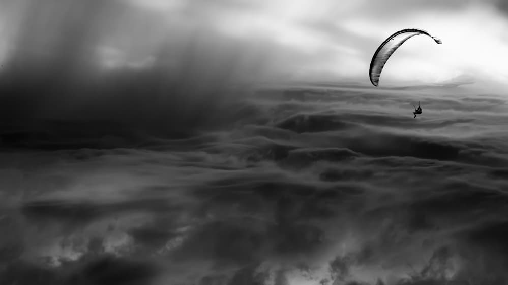 Paraglider Above Storm Clouds by Andrzej Krawczyk Photography — canvas wall art