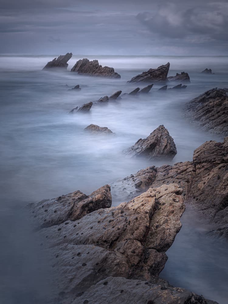 Misty Ocean Rocks by Clara Gamito — canvas wall art