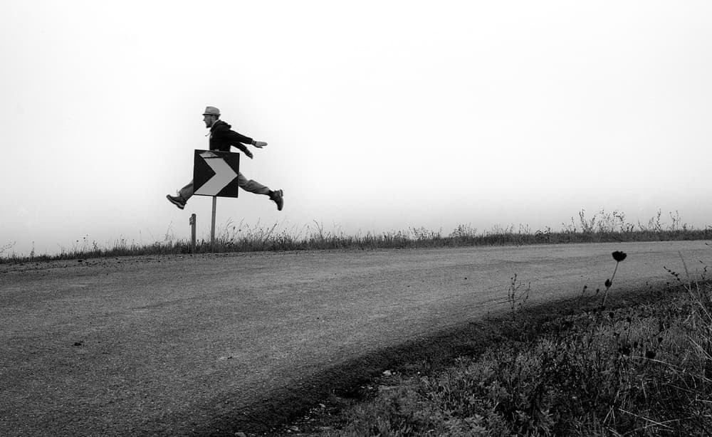 Man Leaping Over Sign by Carlo Ferrara — canvas wall art