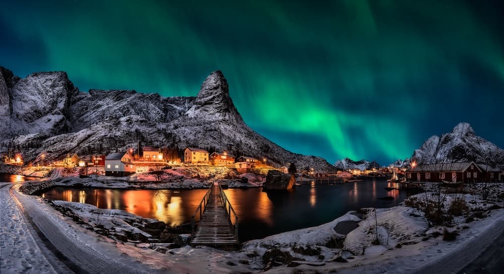 Aurora Over Winter Village by Javier de la Torre — canvas wall art