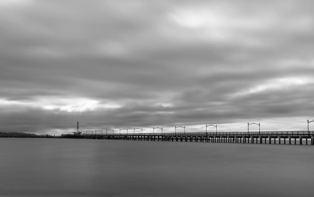 Moody Pier Horizon by Lynann Colligan — canvas wall art