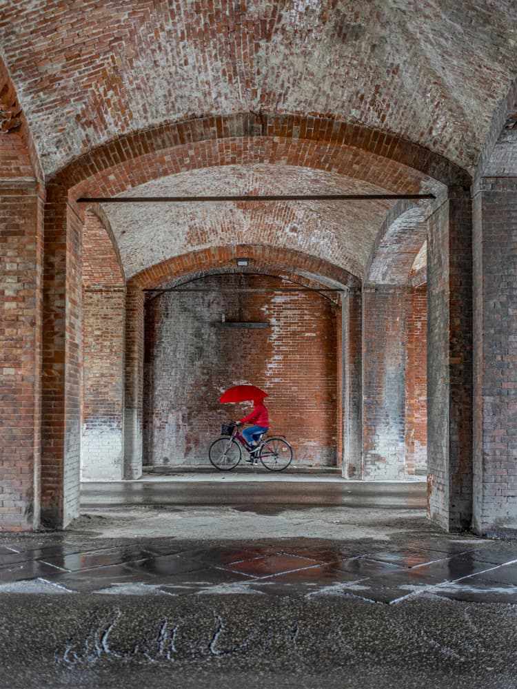 Red Umbrella Under Arches by Massimo Della Latta — canvas wall art