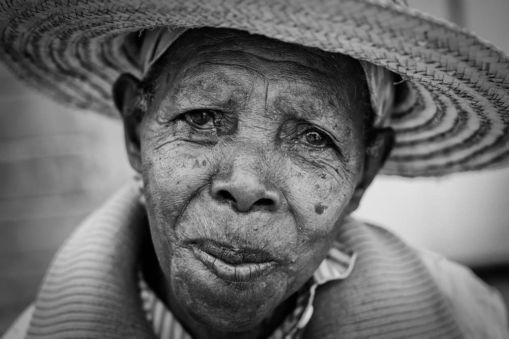 Elderly Woman Straw Hat by Gloria Salgado Gispert — canvas wall art